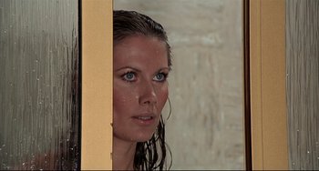 Movie still from “The Man with the Golden Gun” (1974), directed by Guy Hamilton – A beautiful woman with wet hair looking into a mirror; Close Up shot, Over the shoulder angle
