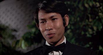 Movie still from “The Man with the Golden Gun” (1974), directed by Guy Hamilton – A person wearing a tuxedo; Close Up shot, Low angle
