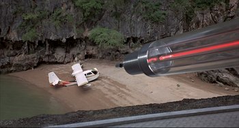 Movie still from “The Man with the Golden Gun” (1974), directed by Guy Hamilton – An airplane flying over a body of water; Extreme Wide shot, High angle