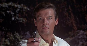 Movie still from “The Man with the Golden Gun” (1974), directed by Guy Hamilton – A person holding a gun; Close Up shot, Low angle