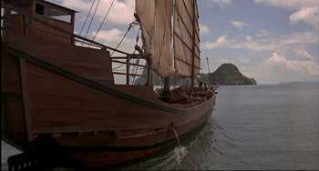 Movie still from “The Man with the Golden Gun” (1974), directed by Guy Hamilton – A large wooden sail boat in the water; Extreme Wide shot, High angle
