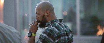Movie still from “Retrograde” (2022), directed by Matthew Heineman – A man with a beard is brushing his teeth; Close Up shot, Low angle