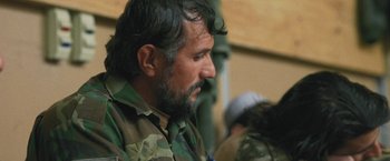 Movie still from “Retrograde” (2022), directed by Matthew Heineman – A person wearing a military uniform; Close Up shot, Over the shoulder angle