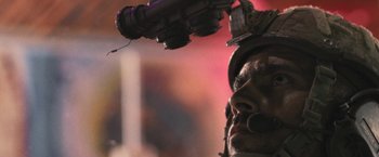 Movie still from “Retrograde” (2022), directed by Matthew Heineman – A man in a helmet is holding a video camera; Extreme Close Up shot, Low angle