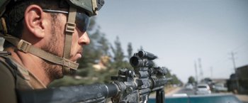 Movie still from “Retrograde” (2022), directed by Matthew Heineman – A soldier is looking through a scope on a rifle; Close Up shot, Low angle