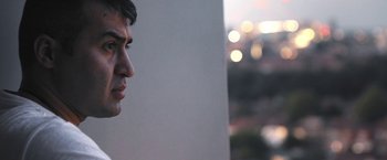 Movie still from “Retrograde” (2022), directed by Matthew Heineman – A person's face looking at a wall; Close Up shot, Low angle