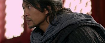 Movie still from “The Man with the Iron Fists” (2012), directed by RZA – A person with long black hair; Close Up shot, Over the shoulder angle