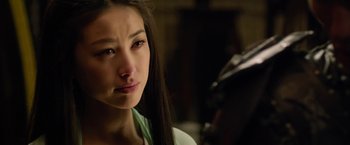 Movie still from “The Man with the Iron Fists” (2012), directed by RZA – A woman with long brown hair is looking at the camera; Close Up shot, Over the shoulder angle