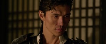 Movie still from “The Man with the Iron Fists” (2012), directed by RZA – A person wearing a leather jacket; Close Up shot, Over the shoulder angle