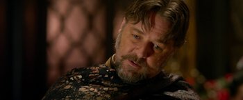 Movie still from “The Man with the Iron Fists” (2012), directed by RZA – A person with a beard; Close Up shot, Over the shoulder angle