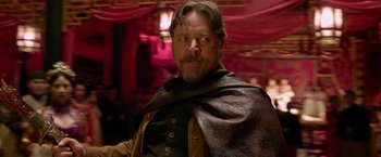 Movie still from “The Man with the Iron Fists” (2012), directed by RZA – A person with a beard; Close Up shot, Over the shoulder angle