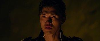 Movie still from “The Man with the Iron Fists” (2012), directed by RZA – A person wearing a black jacket; Close Up shot, Low angle