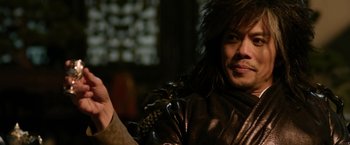 Movie still from “The Man with the Iron Fists” (2012), directed by RZA – A person wearing a leather jacket; Close Up shot, Over the shoulder angle