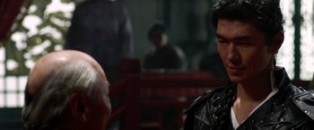 Movie still from “The Man with the Iron Fists” (2012), directed by RZA – A man in a black shirt is standing in a boxing ring; Close Up shot, Over the shoulder angle