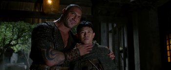 Movie still from “The Man with the Iron Fists” (2012), directed by RZA – A man and a young boy pose for a picture; Medium shot, Low angle