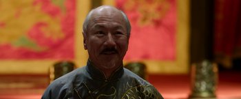 Movie still from “The Man with the Iron Fists” (2012), directed by RZA – An older man wearing a black and gold jacket; Close Up shot, Low angle