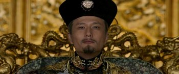 Movie still from “The Man with the Iron Fists” (2012), directed by RZA – A person wearing a hat; Close Up shot, Low angle