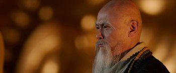 Movie still from “The Man with the Iron Fists” (2012), directed by RZA – An old man with long white hair and a long beard; Close Up shot, Low angle