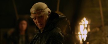 Movie still from “The Man with the Iron Fists” (2012), directed by RZA – A man with blonde hair wearing a black jacket; Close Up shot, Over the shoulder angle