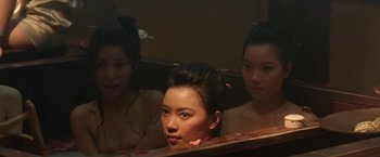 Movie still from “The Man with the Iron Fists” (2012), directed by RZA – A woman sitting in front of two other women in front of a mirror; Close Up shot, High angle