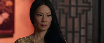 Movie still from “The Man with the Iron Fists” (2012), directed by RZA – A person with long black hair; Close Up shot, Over the shoulder angle