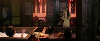 Movie still from “The Man with the Iron Fists” (2012), directed by RZA – Two people are sitting at a table in an oriental restaurant; Wide shot, Over the shoulder angle