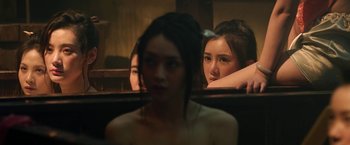 Movie still from “The Man with the Iron Fists” (2012), directed by RZA – A woman sitting in front of a mirror with another woman standing behind her; Close Up shot, Over the shoulder angle