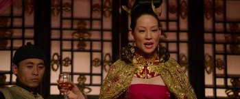 Movie still from “The Man with the Iron Fists” (2012), directed by RZA – A woman in a red and gold dress; Close Up shot, Over the shoulder angle