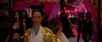 Movie still from “The Man with the Iron Fists” (2012), directed by RZA – A woman dressed in oriental clothing holding a pair of red nails; Close Up shot, Over the shoulder angle