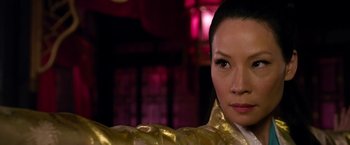 Movie still from “The Man with the Iron Fists” (2012), directed by RZA – A person wearing a gold dress; Close Up shot, Over the shoulder angle