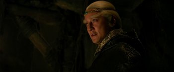 Movie still from “The Man with the Iron Fists” (2012), directed by RZA – A person wearing a crown; Close Up shot, Over the shoulder angle