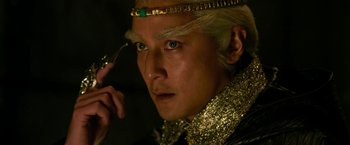 Movie still from “The Man with the Iron Fists” (2012), directed by RZA – A person wearing a costume; Close Up shot, High angle