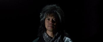 Movie still from “The Man with the Iron Fists” (2012), directed by RZA – A man wearing a wig in the dark; Close Up shot, Low angle