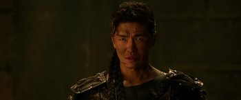 Movie still from “The Man with the Iron Fists” (2012), directed by RZA – A person with a braid; Close Up shot, Over the shoulder angle