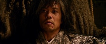 Movie still from “The Man with the Iron Fists” (2012), directed by RZA – A person wearing a robe; Close Up shot, Low angle