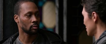 Movie still from “The Man with the Iron Fists” (2012), directed by RZA – A person wearing a black leather jacket; Close Up shot, Over the shoulder angle