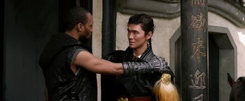 Movie still from “The Man with the Iron Fists” (2012), directed by RZA – A man in a black leather jacket and a man in a black leather jacket; Close Up shot, Over the shoulder angle