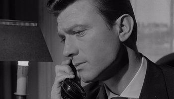 Movie still from “The Manchurian Candidate” (1962), directed by John Frankenheimer – A black and white photo of a man talking on a phone; Close Up shot, High angle