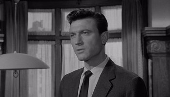 Movie still from “The Manchurian Candidate” (1962), directed by John Frankenheimer – Black and white photograph of a man wearing a suit and tie; Close Up shot, Low angle