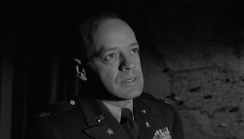 Movie still from “The Manchurian Candidate” (1962), directed by John Frankenheimer – An old photo of a man in a military uniform; Close Up shot, Low angle