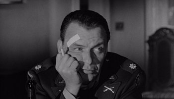 Movie still from “The Manchurian Candidate” (1962), directed by John Frankenheimer – Black and white photograph of a man in military uniform; Close Up shot, Low angle