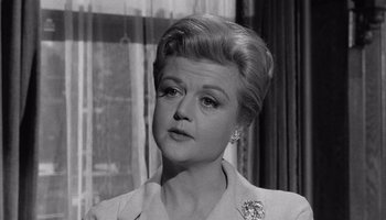 Movie still from “The Manchurian Candidate” (1962), directed by John Frankenheimer – An old black and white photo of a woman; Close Up shot, Over the shoulder angle