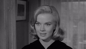 Movie still from “The Manchurian Candidate” (1962), directed by John Frankenheimer – A black and white photo of a woman in a black shirt; Close Up shot, Over the shoulder angle