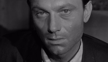 Movie still from “The Manchurian Candidate” (1962), directed by John Frankenheimer – Black and white photograph of a man's face; Close Up shot, High angle