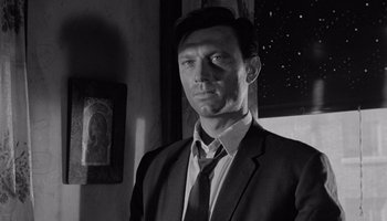 Movie still from “The Manchurian Candidate” (1962), directed by John Frankenheimer – Black and white photograph of a man wearing a suit and tie; Close Up shot, Low angle