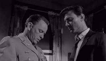 Movie still from “The Manchurian Candidate” (1962), directed by John Frankenheimer – A black - and - white photo of two men looking at one another; Close Up shot, Low angle