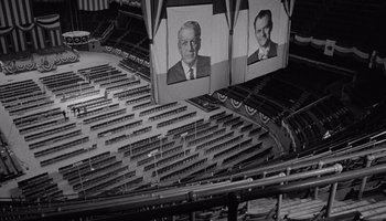 Movie still from “The Manchurian Candidate” (1962), directed by John Frankenheimer – A black - and - white photo of a stadium with seats; Extreme Wide shot, High angle