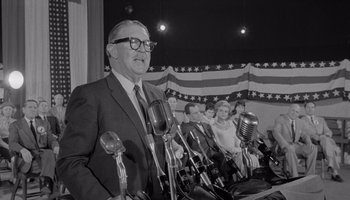 Movie still from “The Manchurian Candidate” (1962), directed by John Frankenheimer – An old photo of a man giving a speech; Medium shot, Low angle