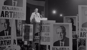 Movie still from “The Manchurian Candidate” (1962), directed by John Frankenheimer – A man is speaking at a political event; Medium shot, High angle