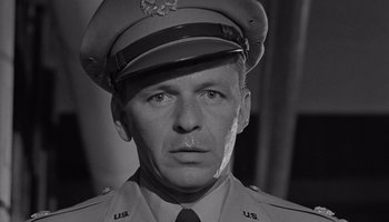 Movie still from “The Manchurian Candidate” (1962), directed by John Frankenheimer – An old photo of a man in a military uniform; Close Up shot, Low angle